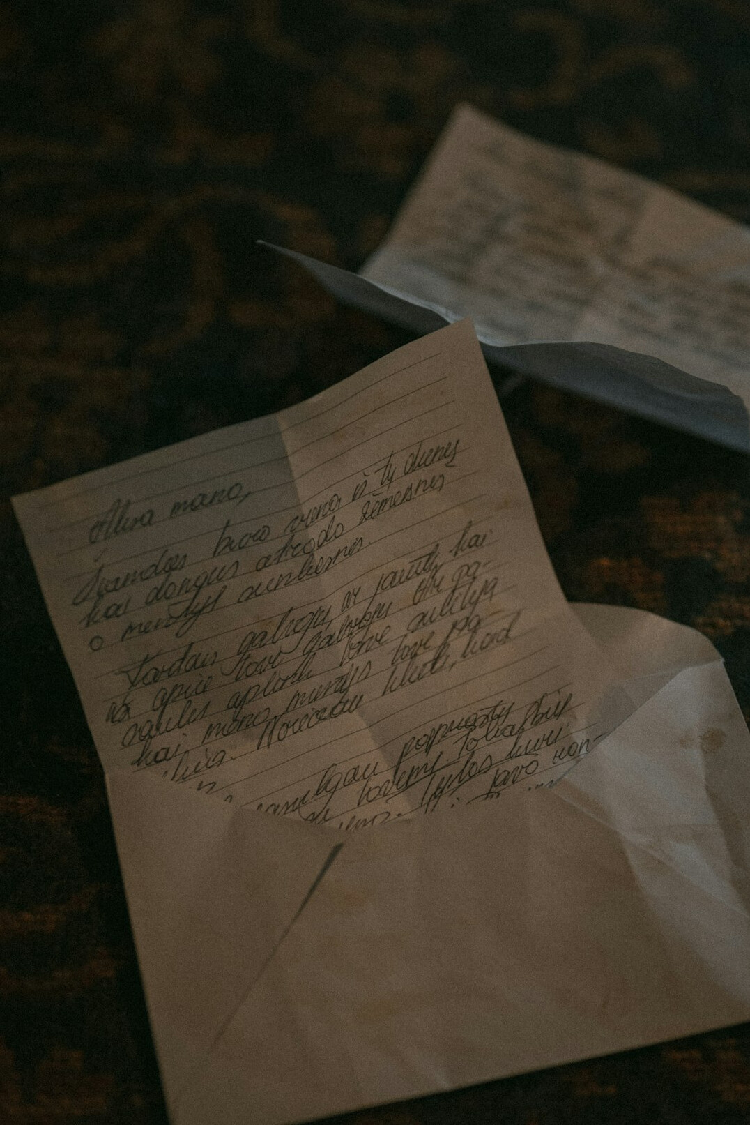 Stack of aged sealed envelopes and documents on a dark table