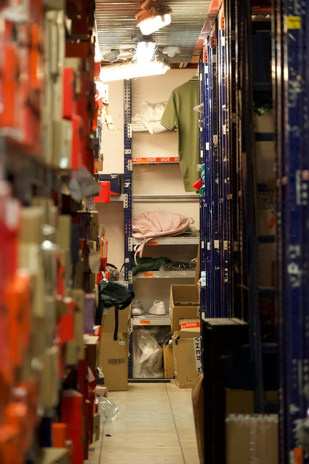 Rows of archival boxes and folders on metal shelving