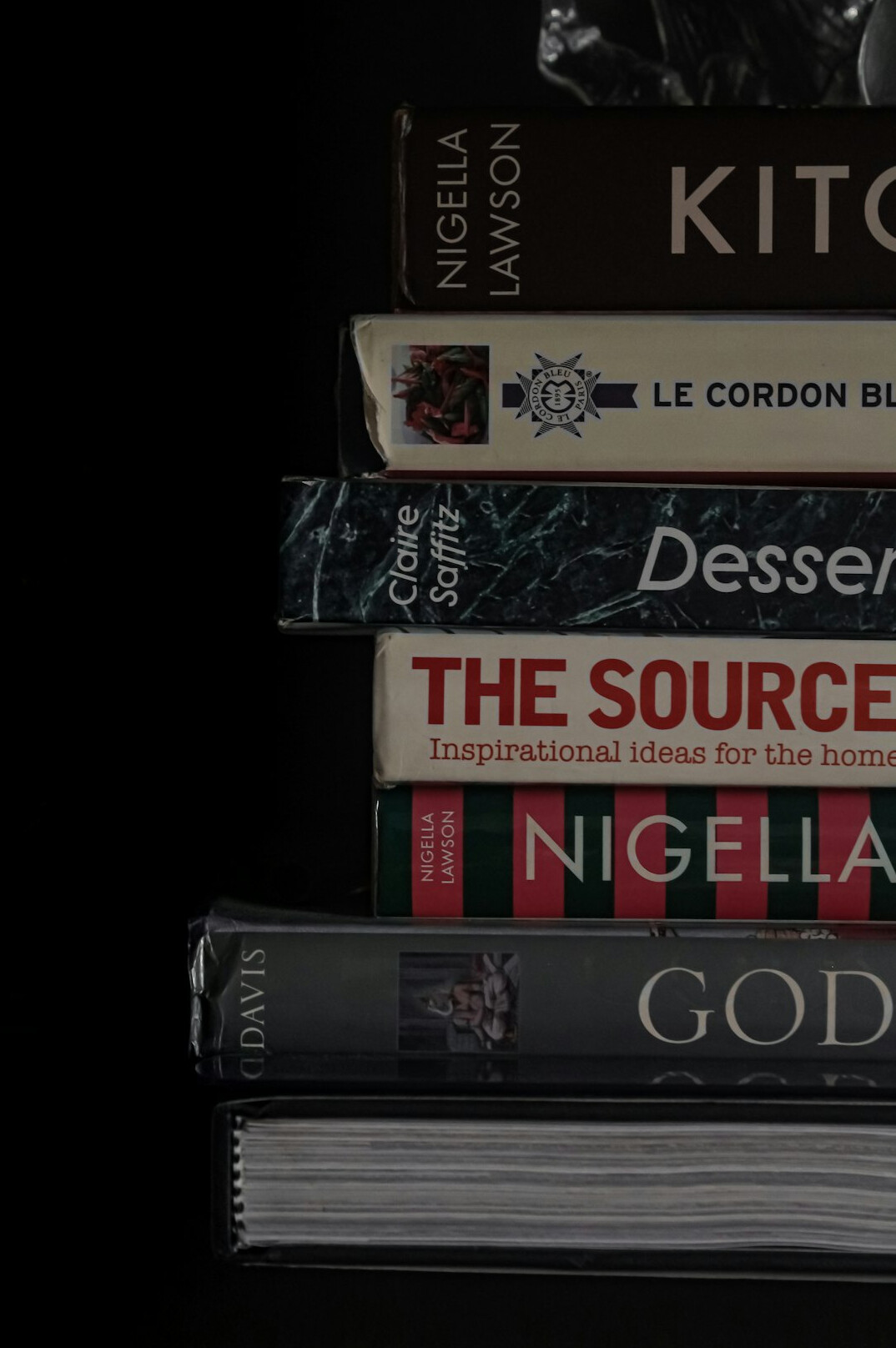Stack of old hardcover novels on a wooden table
